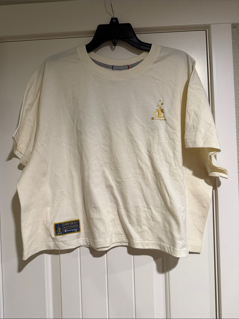 Champion Women’s Cream Short Sleeve Logo Tee with Gold Accent